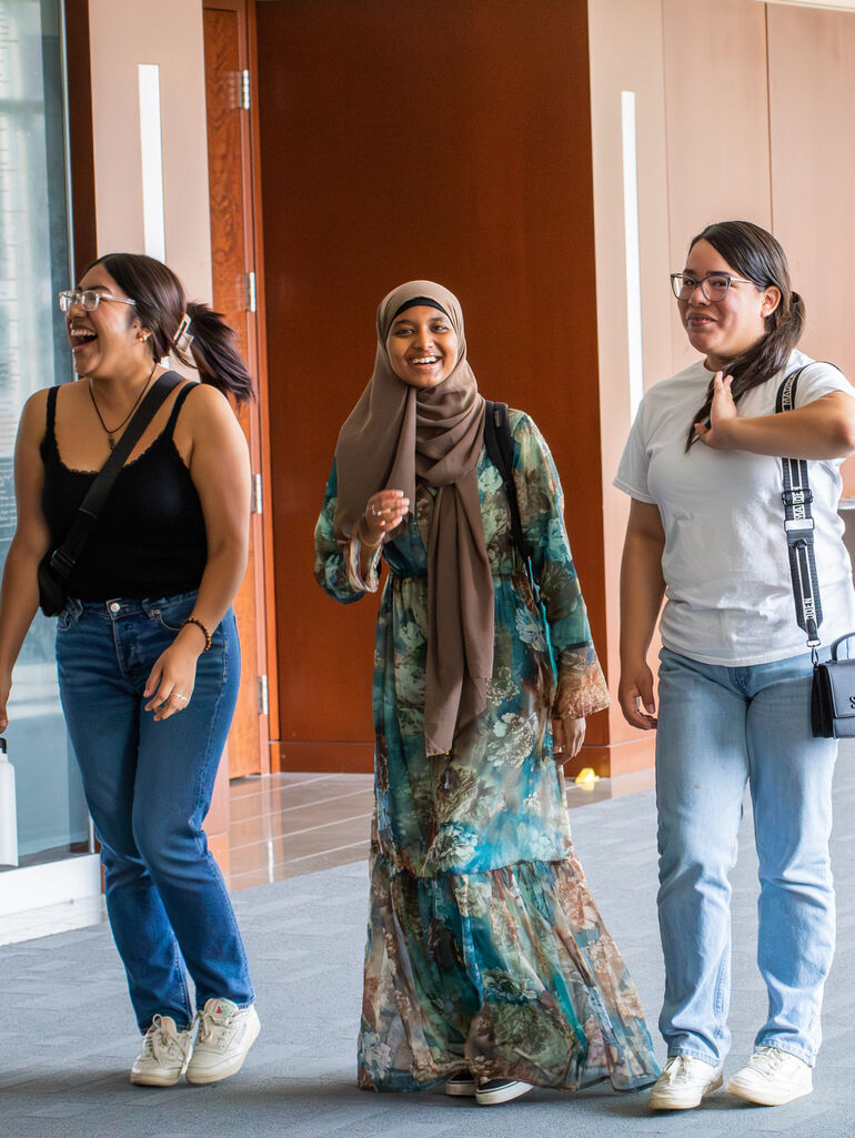 DFC students laughing as walking down hallway