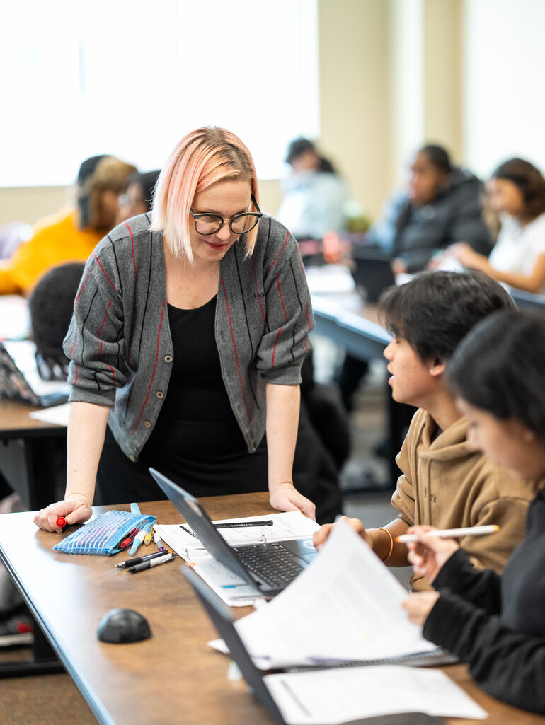  Professor helping students in an Sociology class