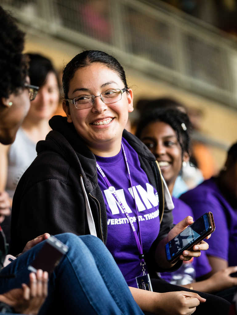 student smiling in an I'm in shirt